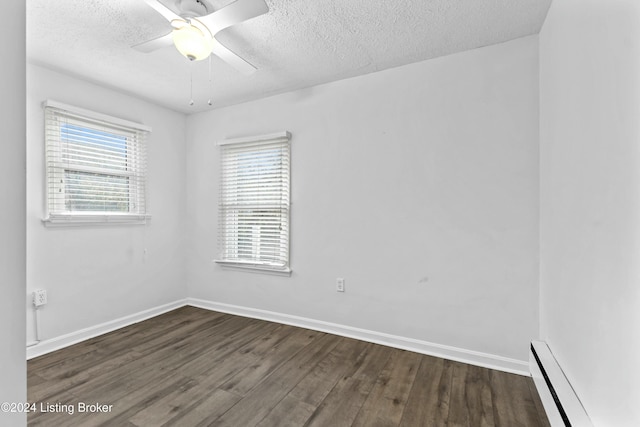 spare room featuring a textured ceiling, dark hardwood / wood-style flooring, a baseboard radiator, and ceiling fan