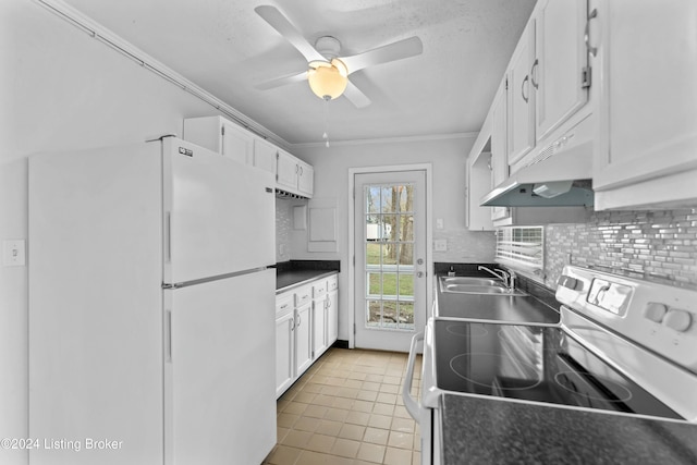 kitchen featuring white cabinets, white refrigerator, range, and sink