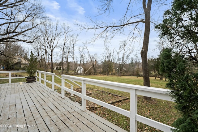 wooden terrace with a lawn