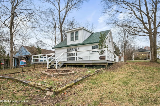 rear view of house featuring a gazebo, a yard, and a wooden deck