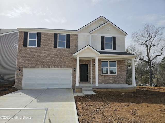 traditional home with a garage, brick siding, driveway, and a porch