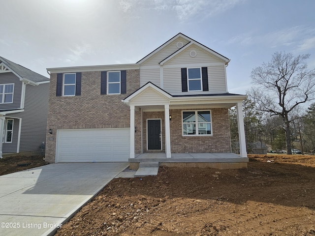 traditional-style home featuring driveway, covered porch, an attached garage, and brick siding