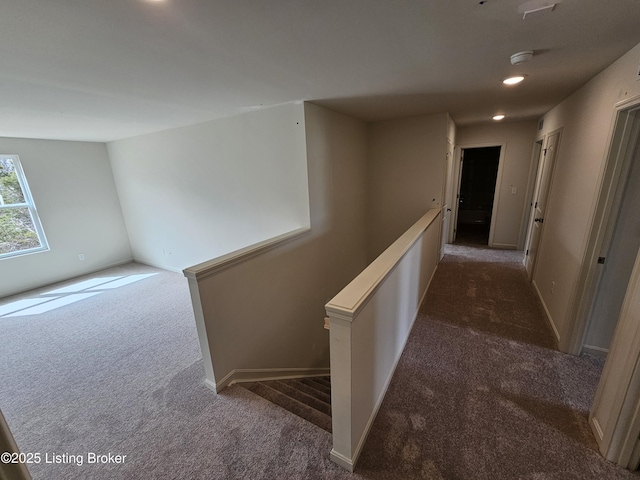 hallway with recessed lighting, baseboards, carpet flooring, and an upstairs landing