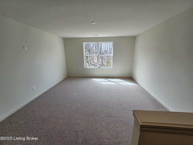 carpeted empty room with visible vents and baseboards