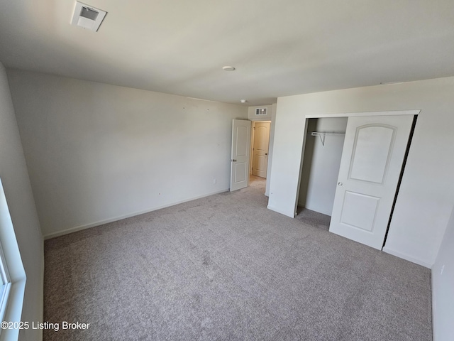 unfurnished bedroom featuring carpet floors, a closet, visible vents, and baseboards