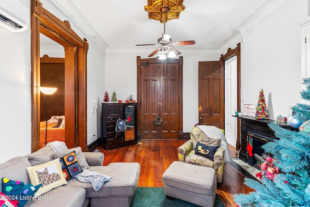 living room with ceiling fan, dark hardwood / wood-style flooring, crown molding, and a wall mounted AC