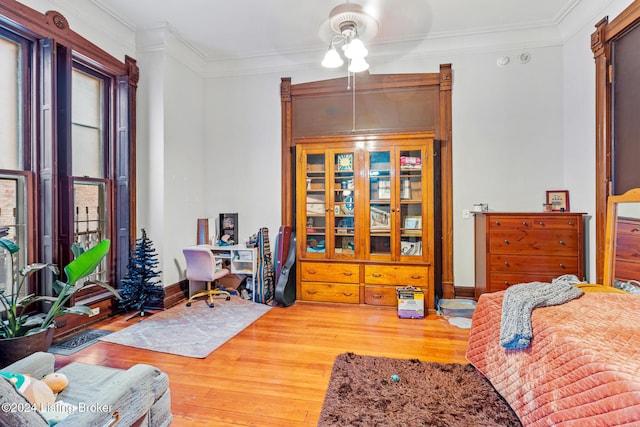 interior space featuring ceiling fan, hardwood / wood-style floors, and ornamental molding