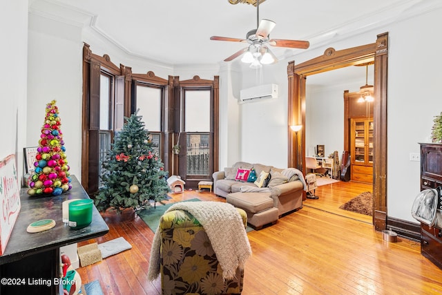 living room featuring hardwood / wood-style floors, a wall mounted air conditioner, and crown molding