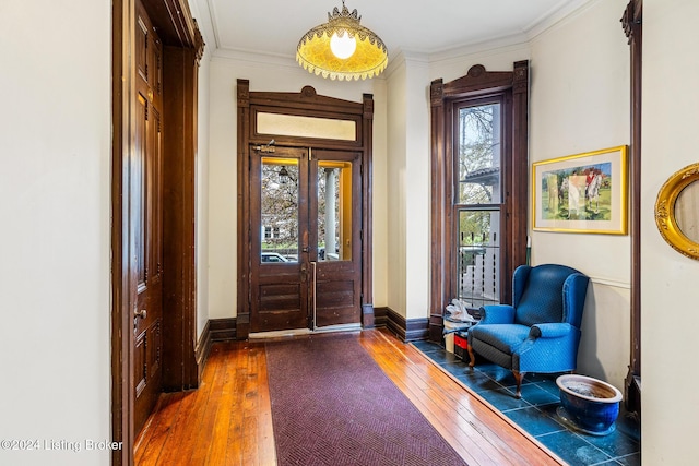 entrance foyer featuring hardwood / wood-style flooring, crown molding, and french doors