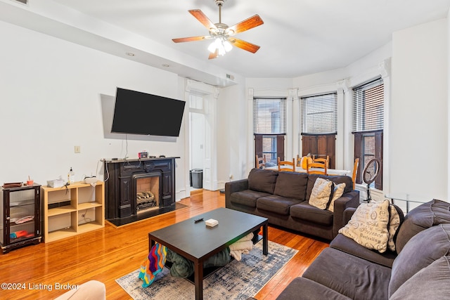 living room featuring ceiling fan and hardwood / wood-style floors