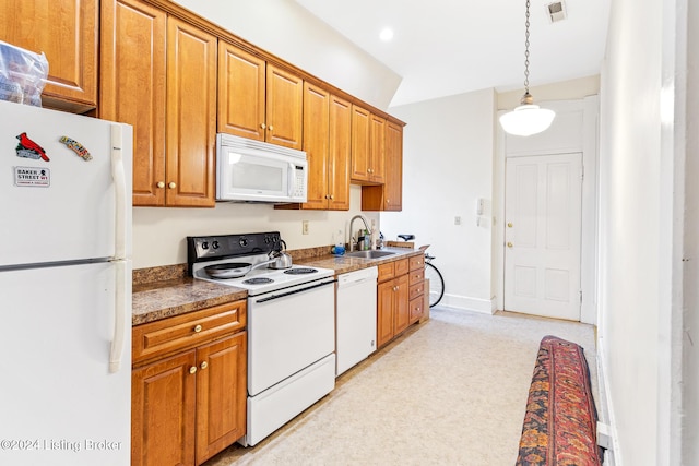 kitchen featuring sink, decorative light fixtures, and white appliances