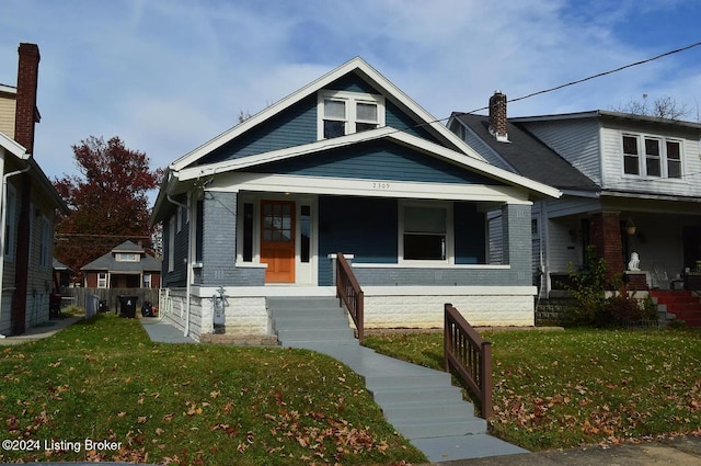 view of front of property with covered porch and a front lawn