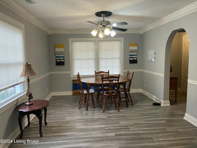 dining room featuring hardwood / wood-style floors, a textured ceiling, ceiling fan, and crown molding