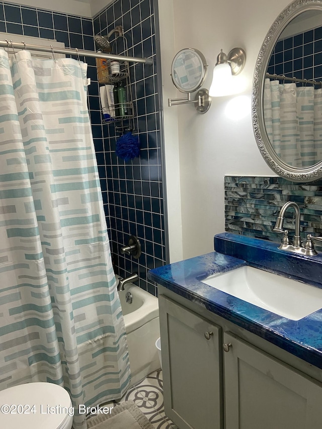 full bathroom with vanity, tasteful backsplash, toilet, and shower / bath combo with shower curtain