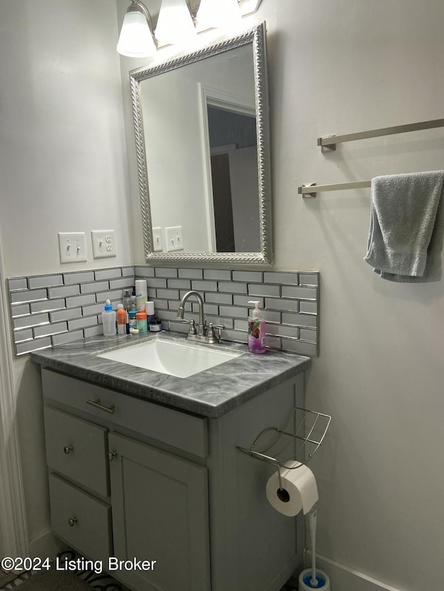 bathroom with vanity and tasteful backsplash