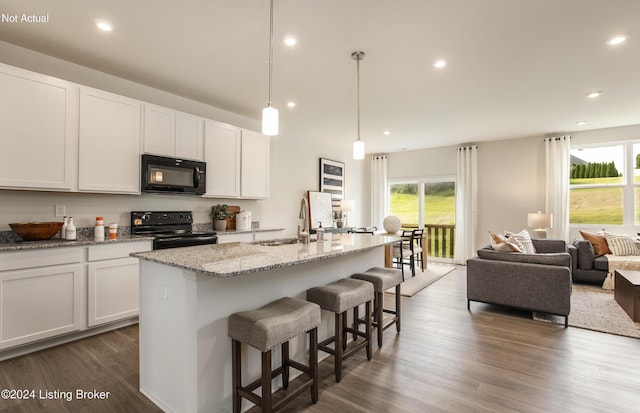 kitchen with white cabinets, sink, a kitchen island with sink, and black appliances