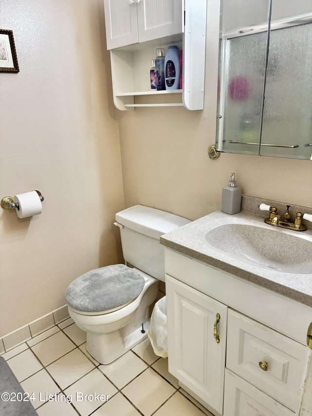 bathroom featuring tile patterned flooring, vanity, and toilet