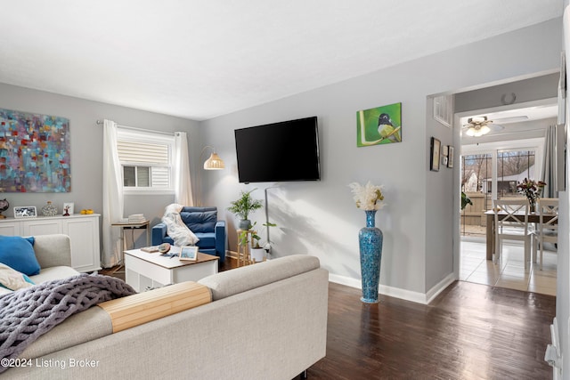 living room with dark hardwood / wood-style floors, a healthy amount of sunlight, and ceiling fan