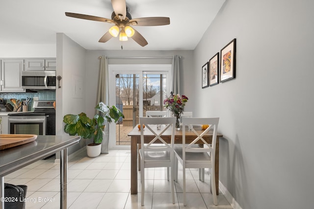 dining space featuring ceiling fan and light tile patterned flooring