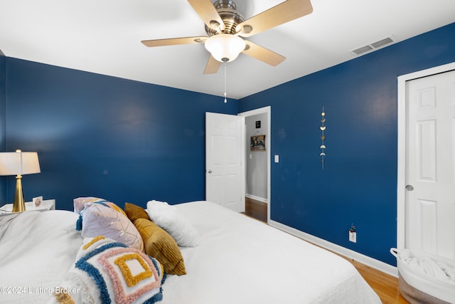 bedroom with ceiling fan and hardwood / wood-style flooring