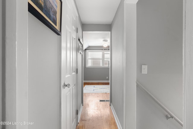 hallway with hardwood / wood-style flooring