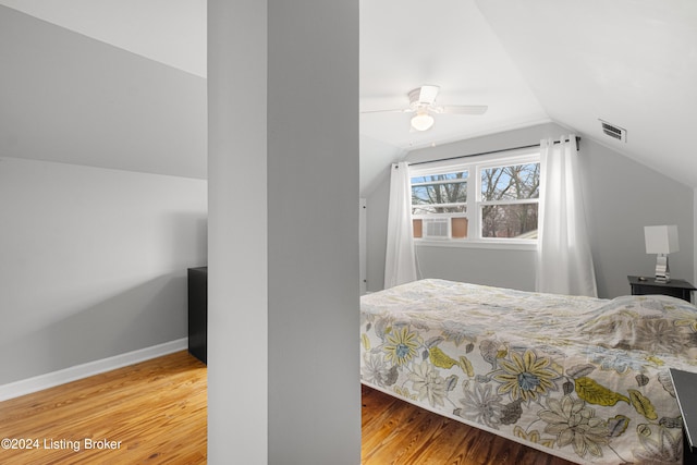 bedroom featuring ceiling fan, wood-type flooring, and vaulted ceiling