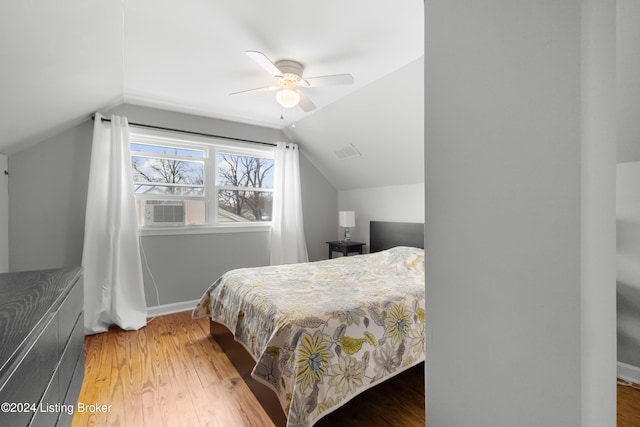 bedroom featuring hardwood / wood-style floors, ceiling fan, and vaulted ceiling