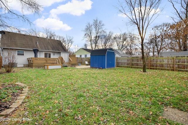 view of yard with a wooden deck and a shed