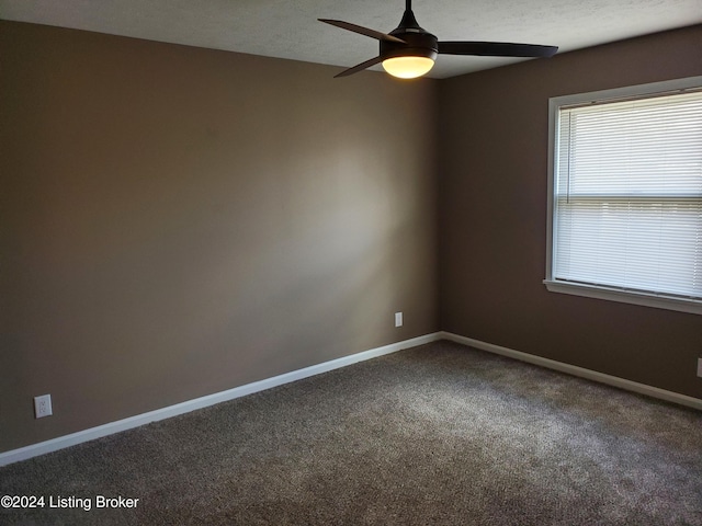 spare room with carpet flooring and ceiling fan