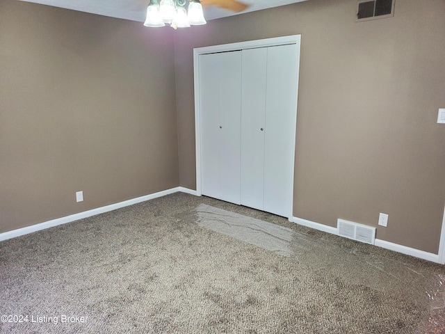 unfurnished bedroom featuring carpet, ceiling fan, and a closet