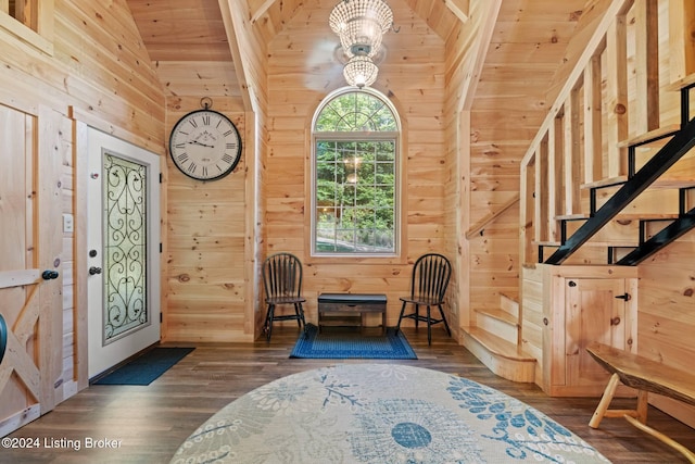 foyer entrance featuring lofted ceiling, wooden walls, wooden ceiling, and dark hardwood / wood-style floors