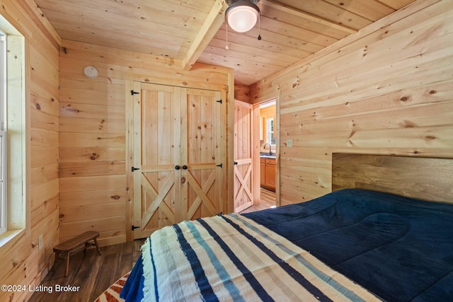 unfurnished bedroom with wood-type flooring, wooden ceiling, ceiling fan, and wooden walls