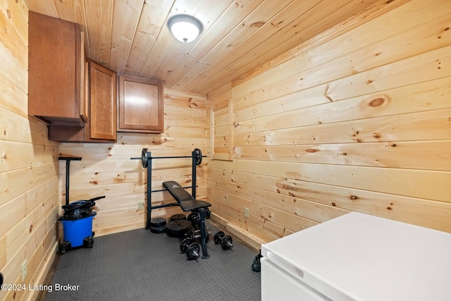 workout area with wooden ceiling, carpet floors, and wooden walls