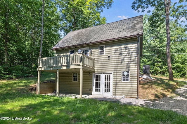 rear view of house with a yard, central AC, a patio area, and a wooden deck