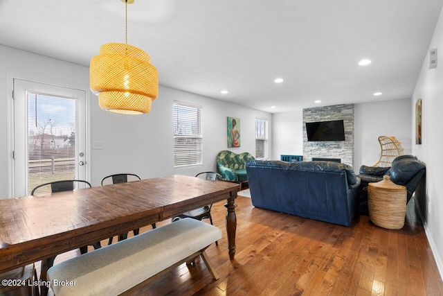 dining area featuring hardwood / wood-style floors, a fireplace, and a wealth of natural light