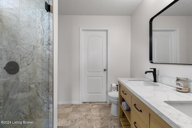 bathroom with a shower, vanity, and toilet