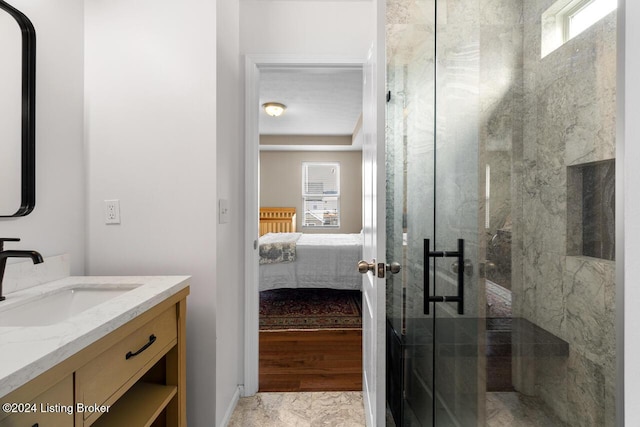 bathroom with vanity, a healthy amount of sunlight, and an enclosed shower