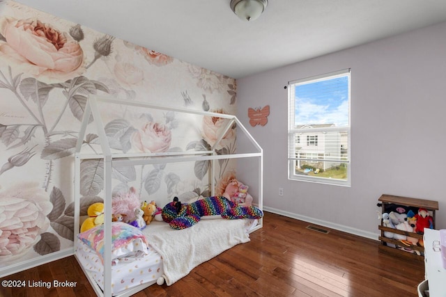 bedroom with dark hardwood / wood-style floors