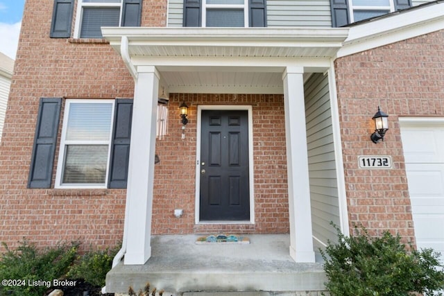 view of exterior entry with a garage