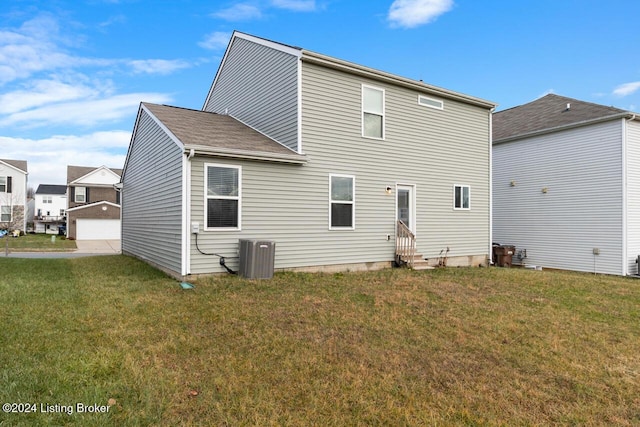 back of house with a lawn and central air condition unit