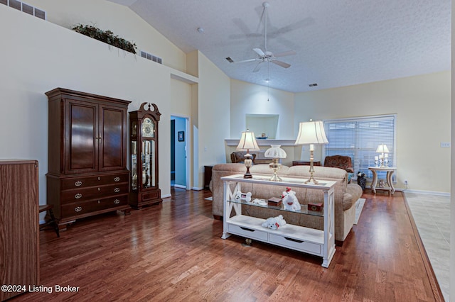 bedroom with dark hardwood / wood-style flooring, lofted ceiling, and a textured ceiling