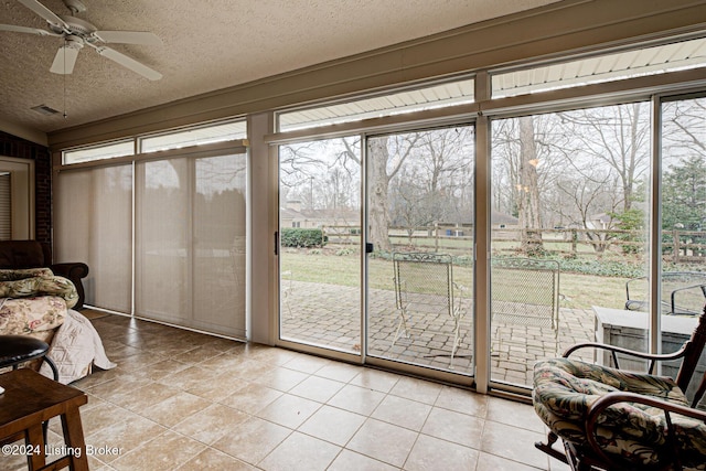 sunroom featuring ceiling fan