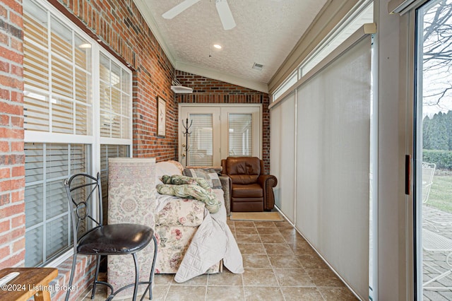 sunroom featuring a wealth of natural light, ceiling fan, and lofted ceiling