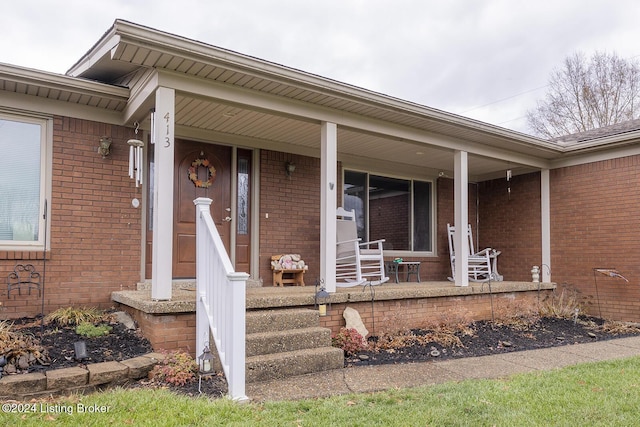 view of exterior entry with covered porch