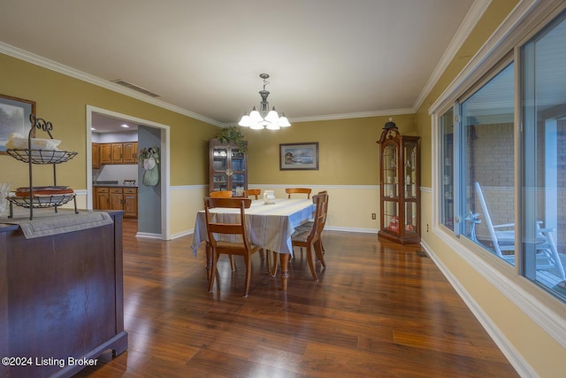 dining room featuring ornamental molding, dark hardwood / wood-style floors, and a notable chandelier