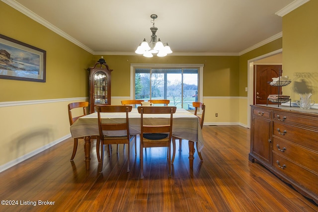 dining area with dark hardwood / wood-style flooring, ornamental molding, and a chandelier