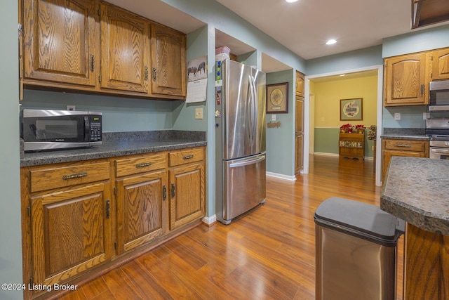 kitchen featuring appliances with stainless steel finishes and light hardwood / wood-style floors