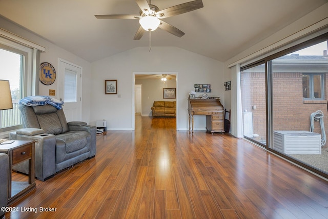 living room with lofted ceiling, dark hardwood / wood-style floors, and ceiling fan