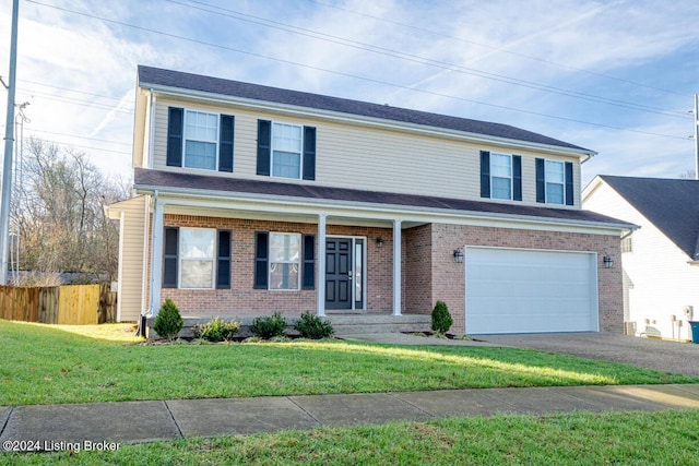 front facade featuring a front lawn and a garage