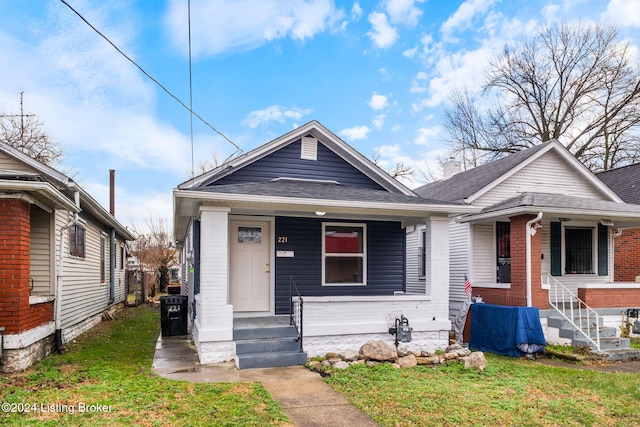 bungalow-style home with a front yard